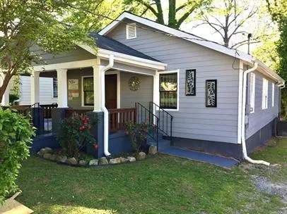 a view of a house with a yard and plants