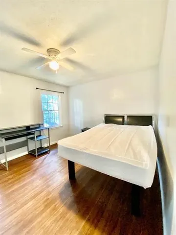 a bed sitting in a bedroom next to a window