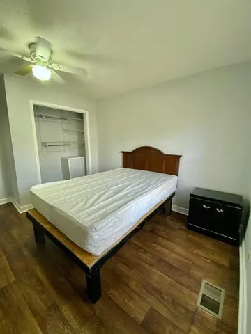 a bedroom with a bed and lamp