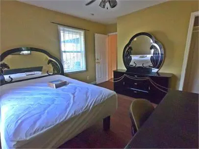 a bedroom with a bed and a mirror