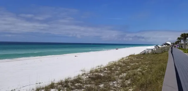 a front view of a building with cars parked