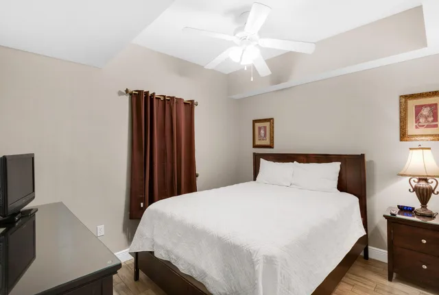 a bedroom with a bed and painting on the wall