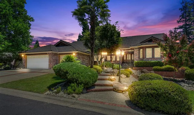 a view of a house with a yard and tree s