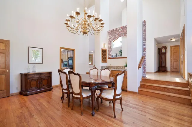 a kitchen with stainless steel appliances granite countertop wooden cabinets a sink and dishwasher with wooden floor