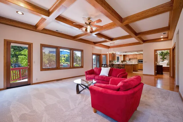 a spacious bedroom with a large bed and a chandelier