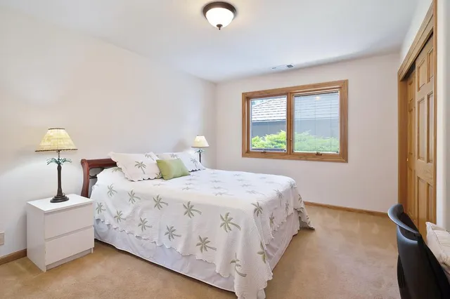 a bathroom with a granite countertop sink a light fixture and a mirror
