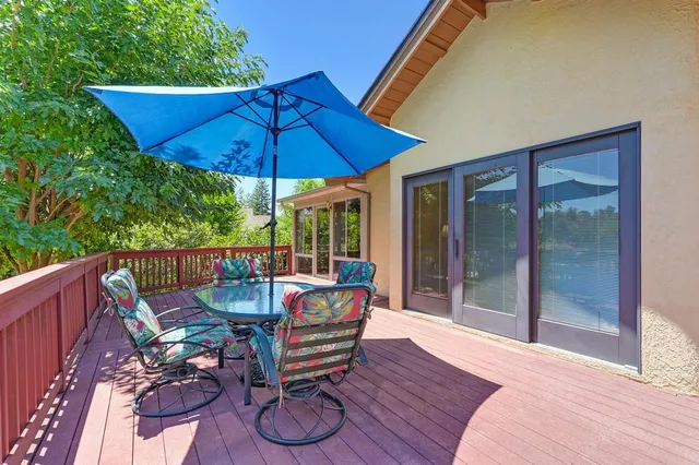 a view of backyard with outdoor seating and green space