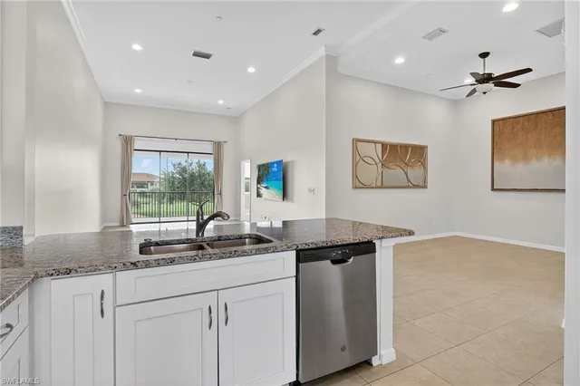 a kitchen with granite countertop a sink and a stove top oven