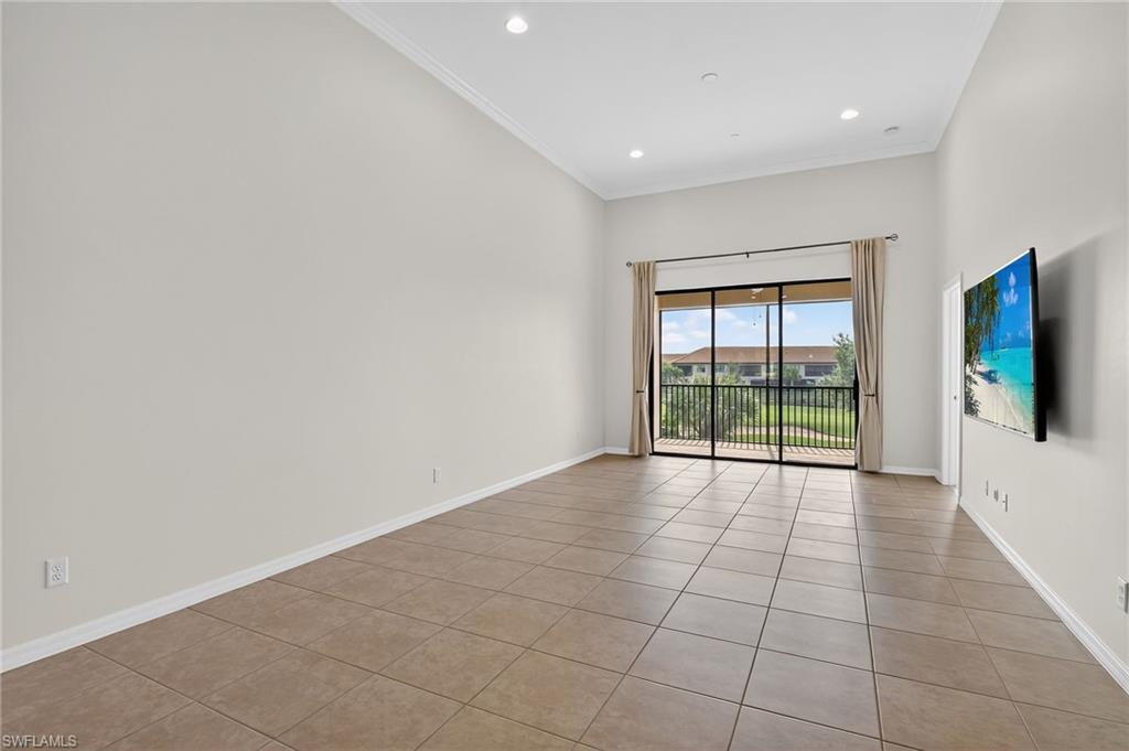 9386 Pocida Court, Unit 202 Naples, FL 34119 - Photo 17 of 38 Empty room with light tile patterned flooring, crown molding, and recessed lighting