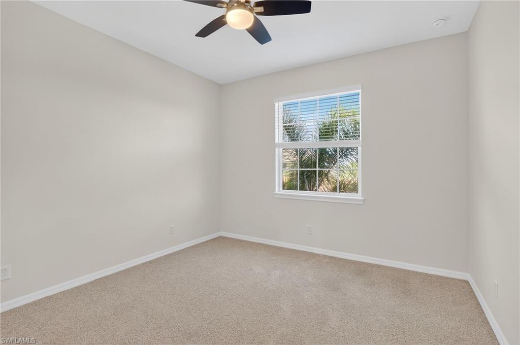 9386 Pocida Court, Unit 202 Naples, FL 34119 - Photo 21 of 38 Spare room with ceiling fan and light colored carpet