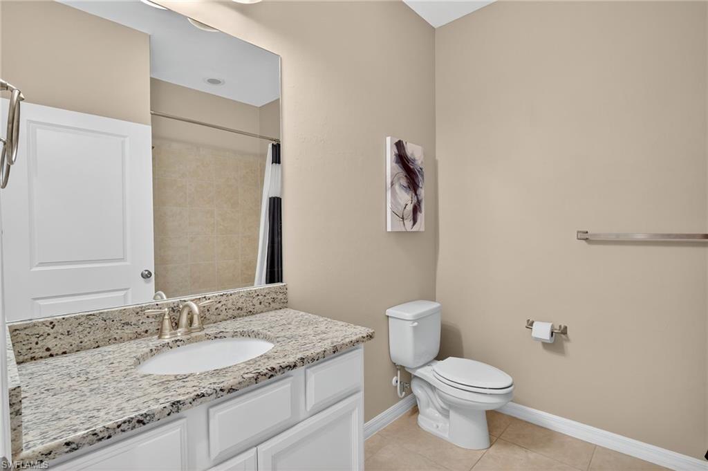 9386 Pocida Court, Unit 202 Naples, FL 34119 - Photo 23 of 38 Full bath with vanity, tile patterned floors, and a shower with curtain