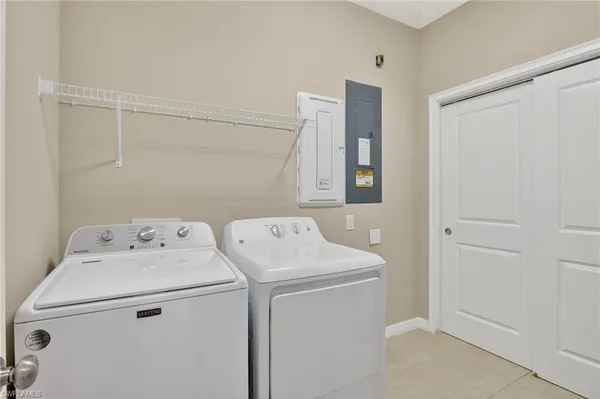 an empty room with a window and a ceiling fan