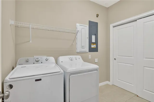 an empty room with a window and a ceiling fan