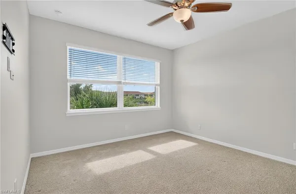 a view of room with window and ceiling fan