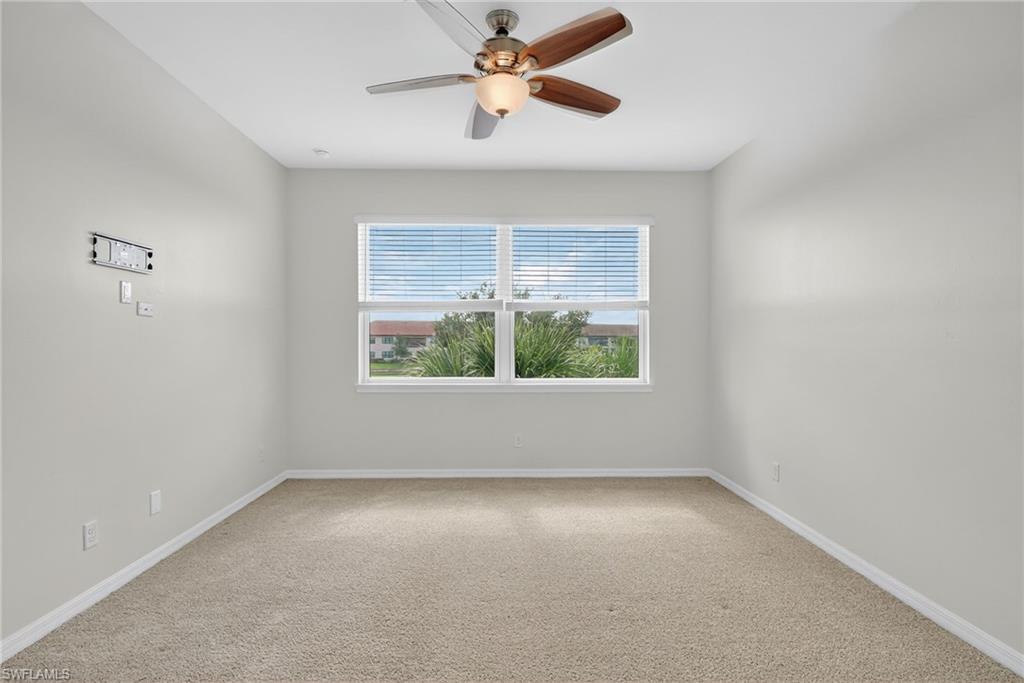 9386 Pocida Court, Unit 202 Naples, FL 34119 - Photo 27 of 38 Spare room featuring carpet and ceiling fan