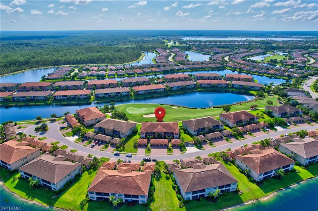 9386 Pocida Court, Unit 202 Naples, FL 34119 - Photo 36 of 38 Aerial perspective of suburban area featuring a nearby body of water and a golf club