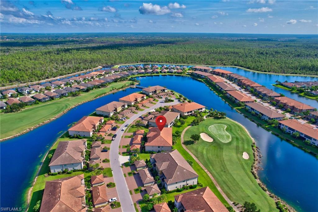 9386 Pocida Court, Unit 202 Naples, FL 34119 - Photo 37 of 38 Aerial perspective of suburban area featuring a forest and a local golf course