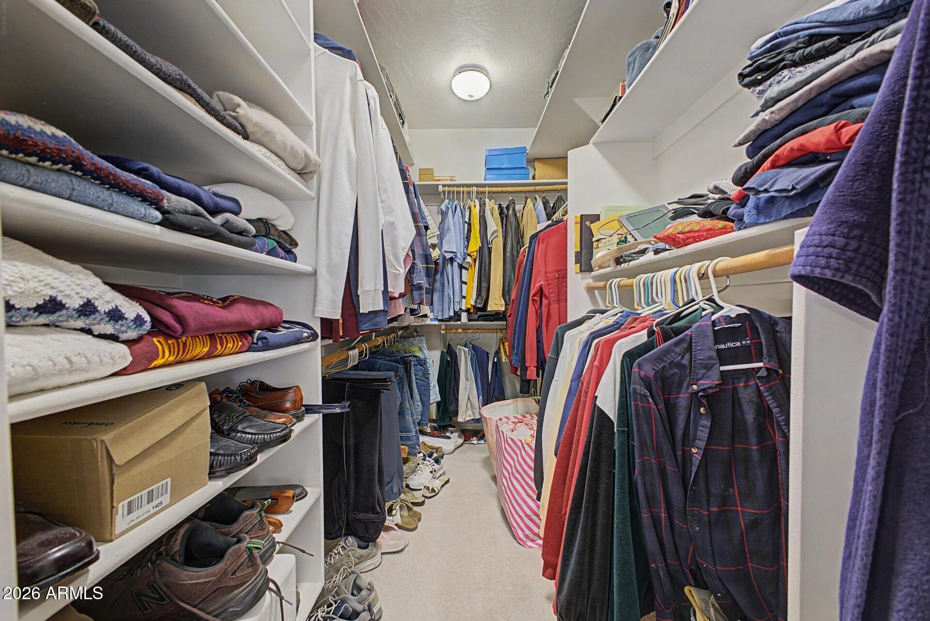 3302 East Draper Circle Mesa, AZ 85213 - Photo 23 of 42 a view of walk in closet with clothes and shoes