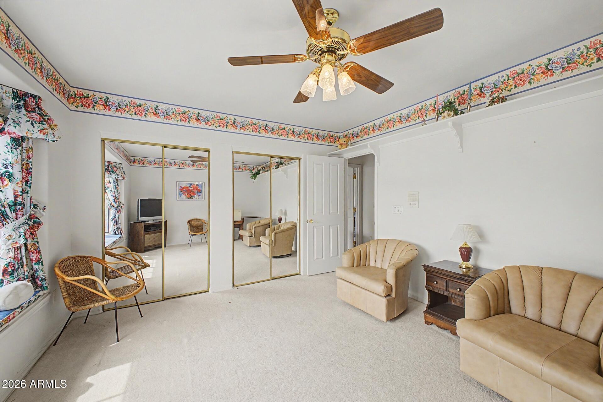3302 East Draper Circle Mesa, AZ 85213 - Photo 25 of 42 a living room with furniture and a chandelier