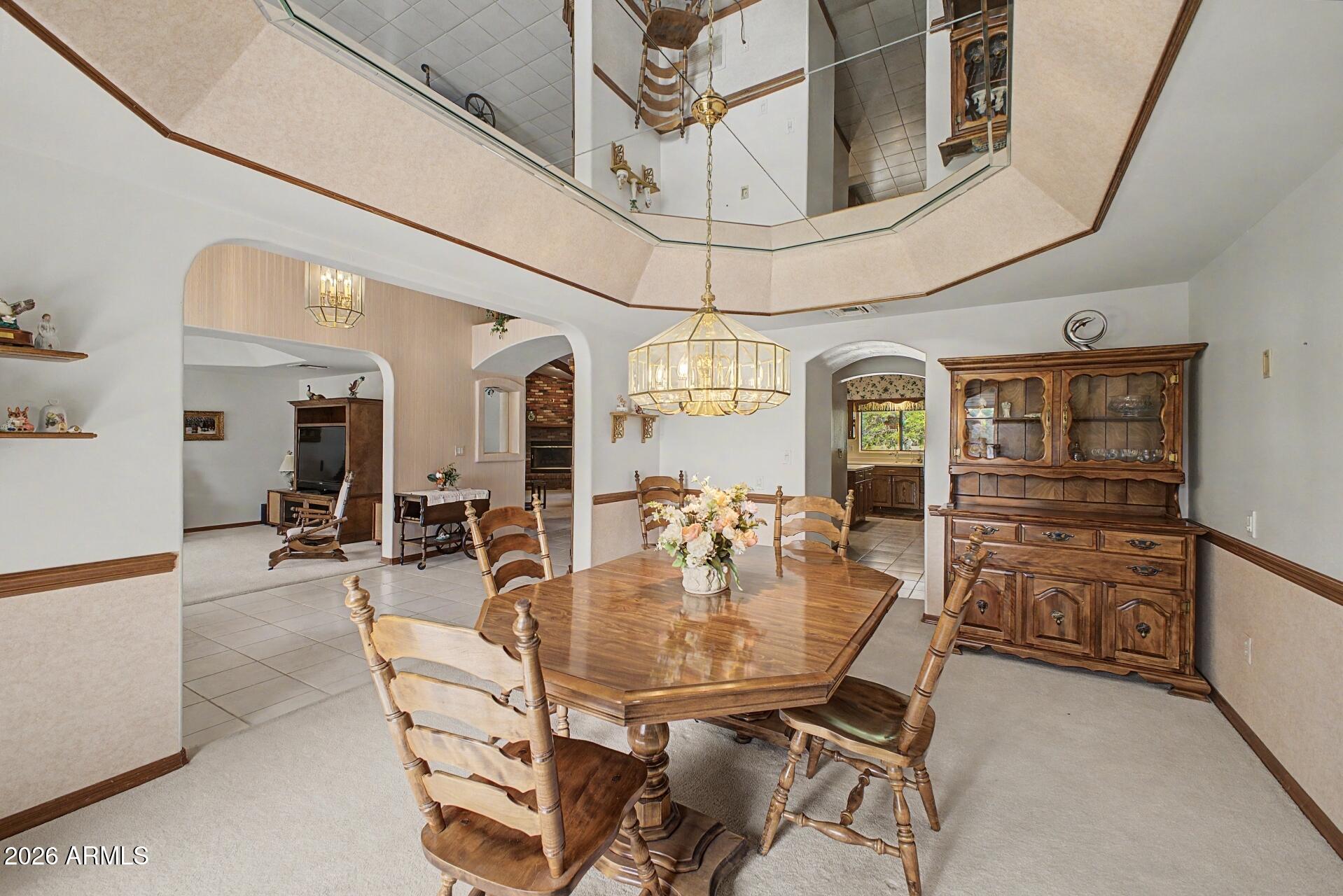3302 East Draper Circle Mesa, AZ 85213 - Photo 10 of 42 a dining room with furniture and a chandelier