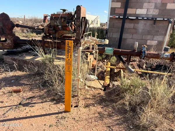 a view of a dry yard with a stove