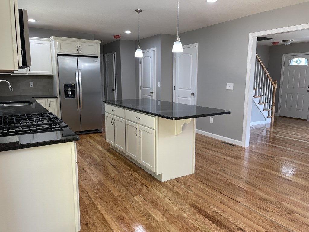 24 Blodgett Street Springfield, MA 01108 - Photo 5 of 26 a kitchen with stainless steel appliances a refrigerator and a stove top oven