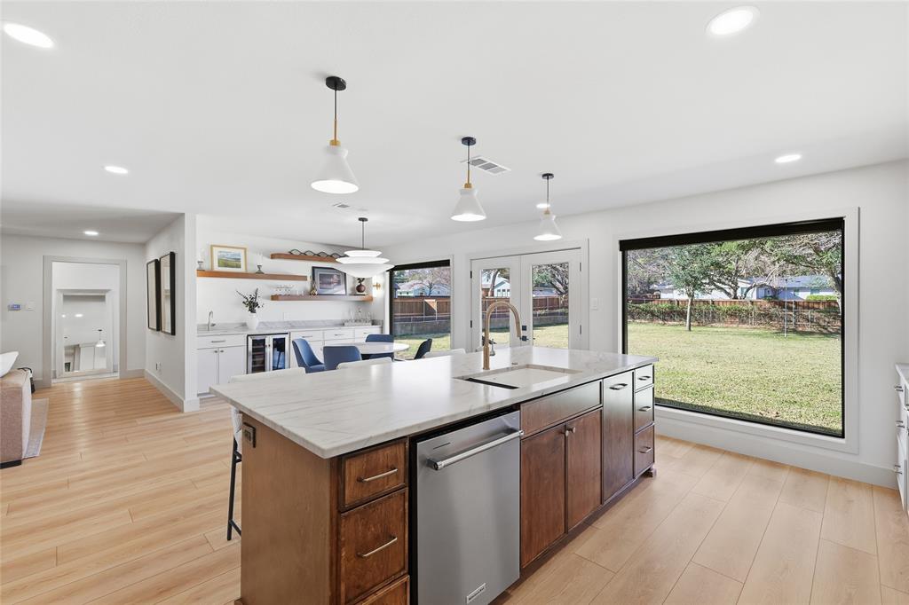 3611 High Drive Grapevine, TX 76051 - Photo 14 of 40 a kitchen with stainless steel appliances granite countertop a sink a stove and a wooden floors