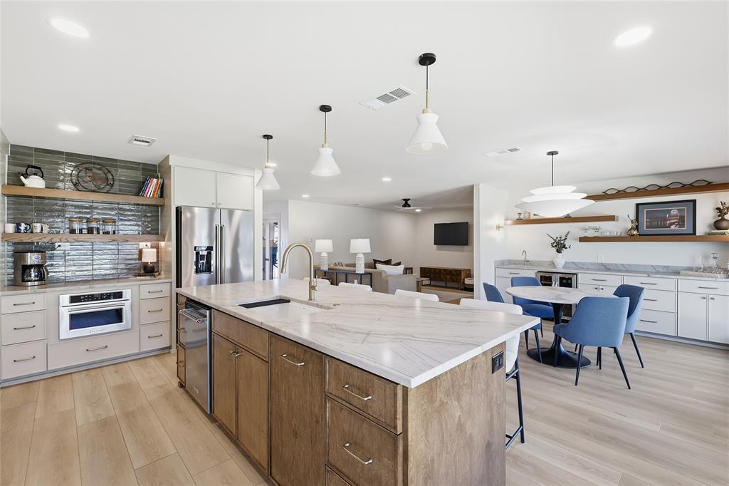 3611 High Drive Grapevine, TX 76051 - Photo 10 of 40 a large kitchen with kitchen island a sink table and chairs