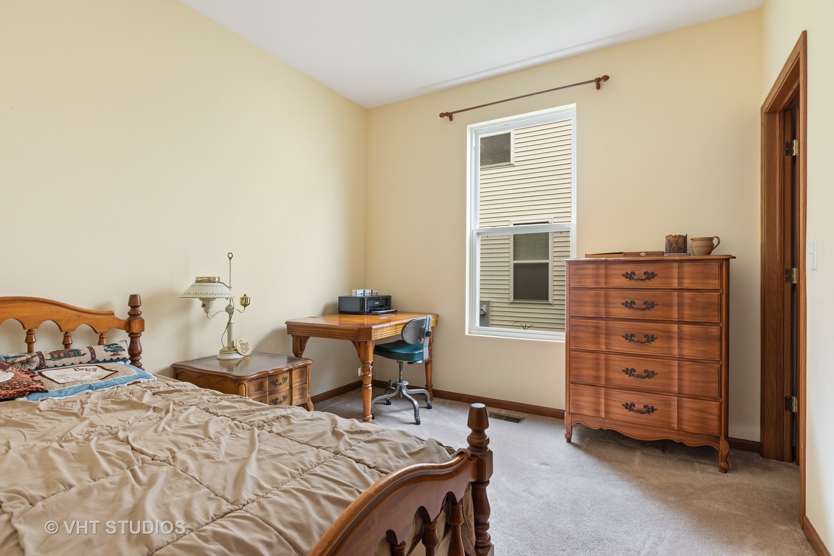 1801 Butterfield Road Woodstock, IL 60098 - Photo 11 of 19 a bedroom with a bed and a desk