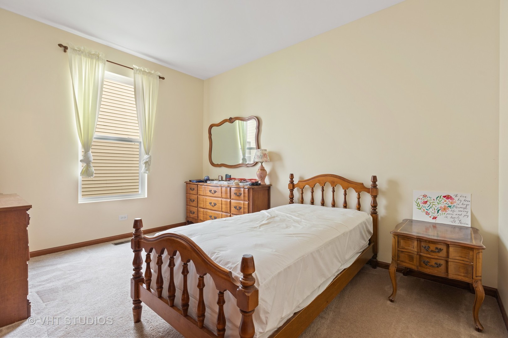 1801 Butterfield Road Woodstock, IL 60098 - Photo 12 of 19 a bedroom with a bed and a window