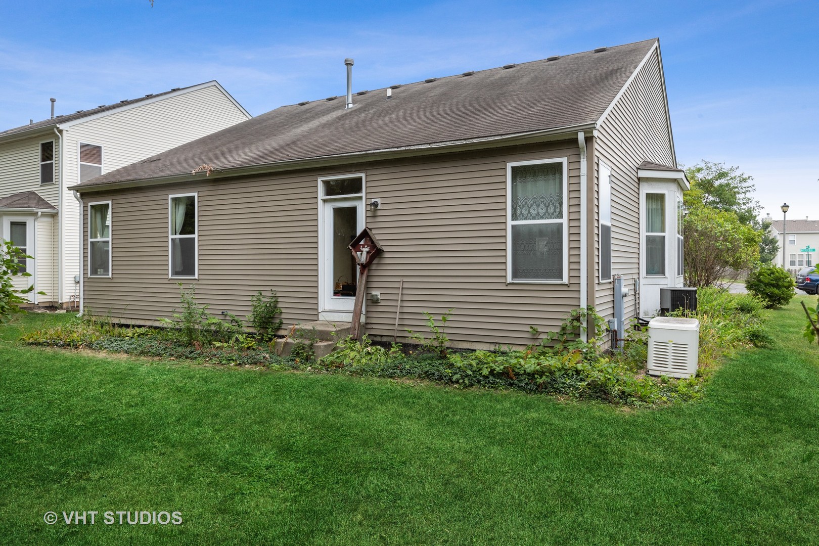 1801 Butterfield Road Woodstock, IL 60098 - Photo 14 of 19 a front view of a house with a garden
