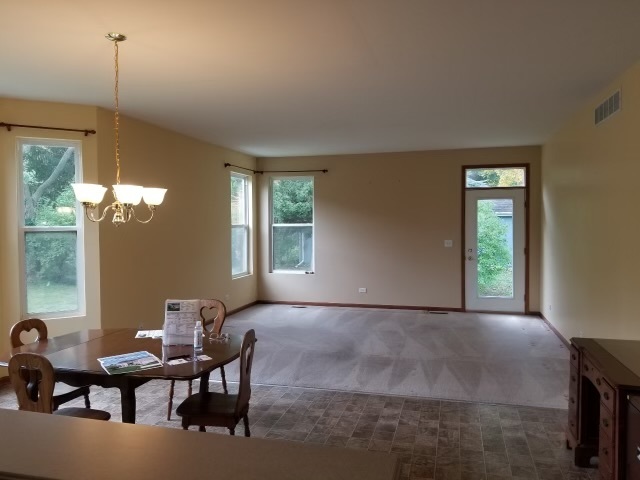 1801 Butterfield Road Woodstock, IL 60098 - Photo 18 of 19 a view of a livingroom with furniture and window