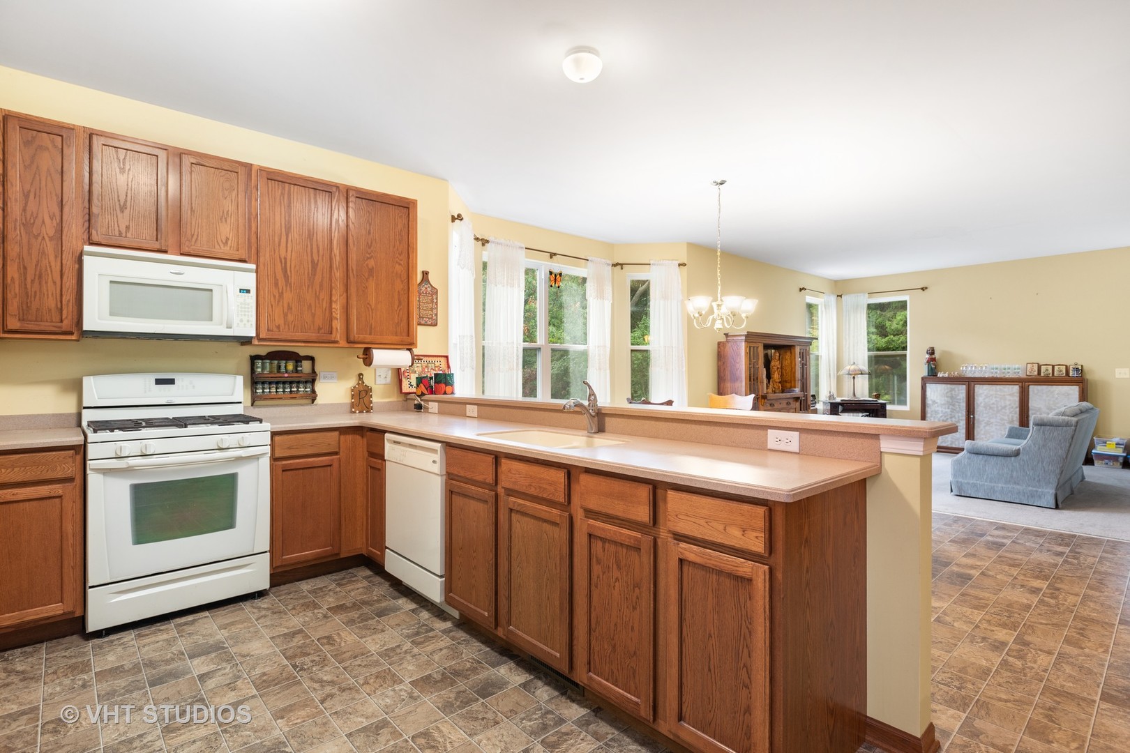 1801 Butterfield Road Woodstock, IL 60098 - Photo 3 of 19 a kitchen with stainless steel appliances granite countertop a stove a sink and a microwave