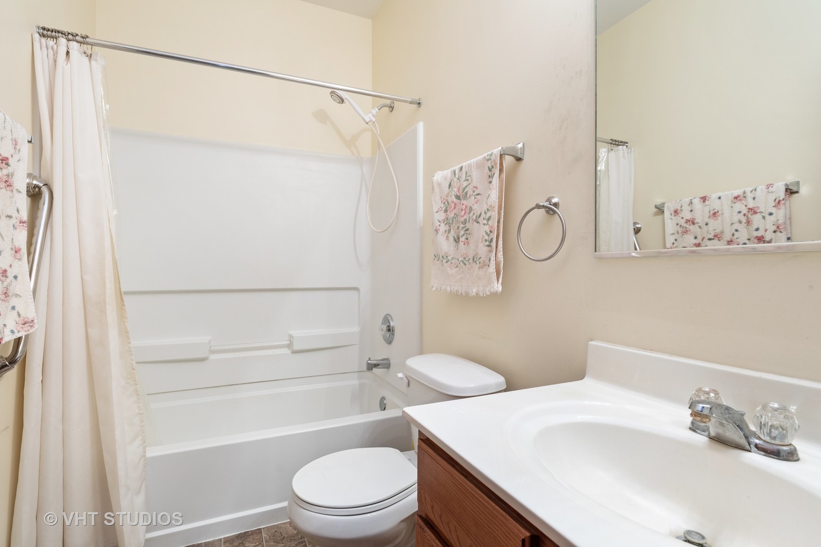 1801 Butterfield Road Woodstock, IL 60098 - Photo 10 of 19 a bathroom with a sink a toilet and shower