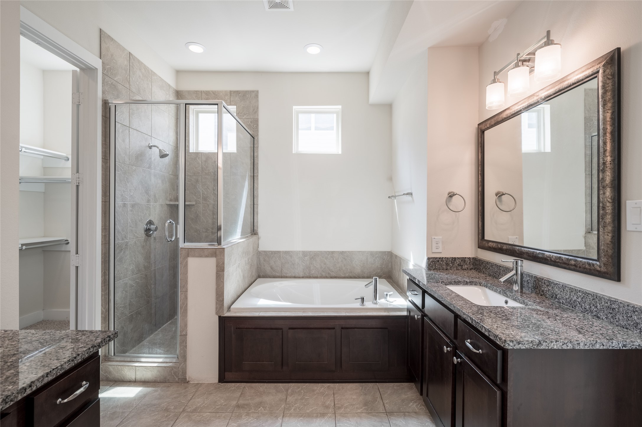 4408 Eli Street, Unit A Houston, TX 77007 - Photo 14 of 22 a spacious bathroom with a granite countertop tub sink shower and mirror