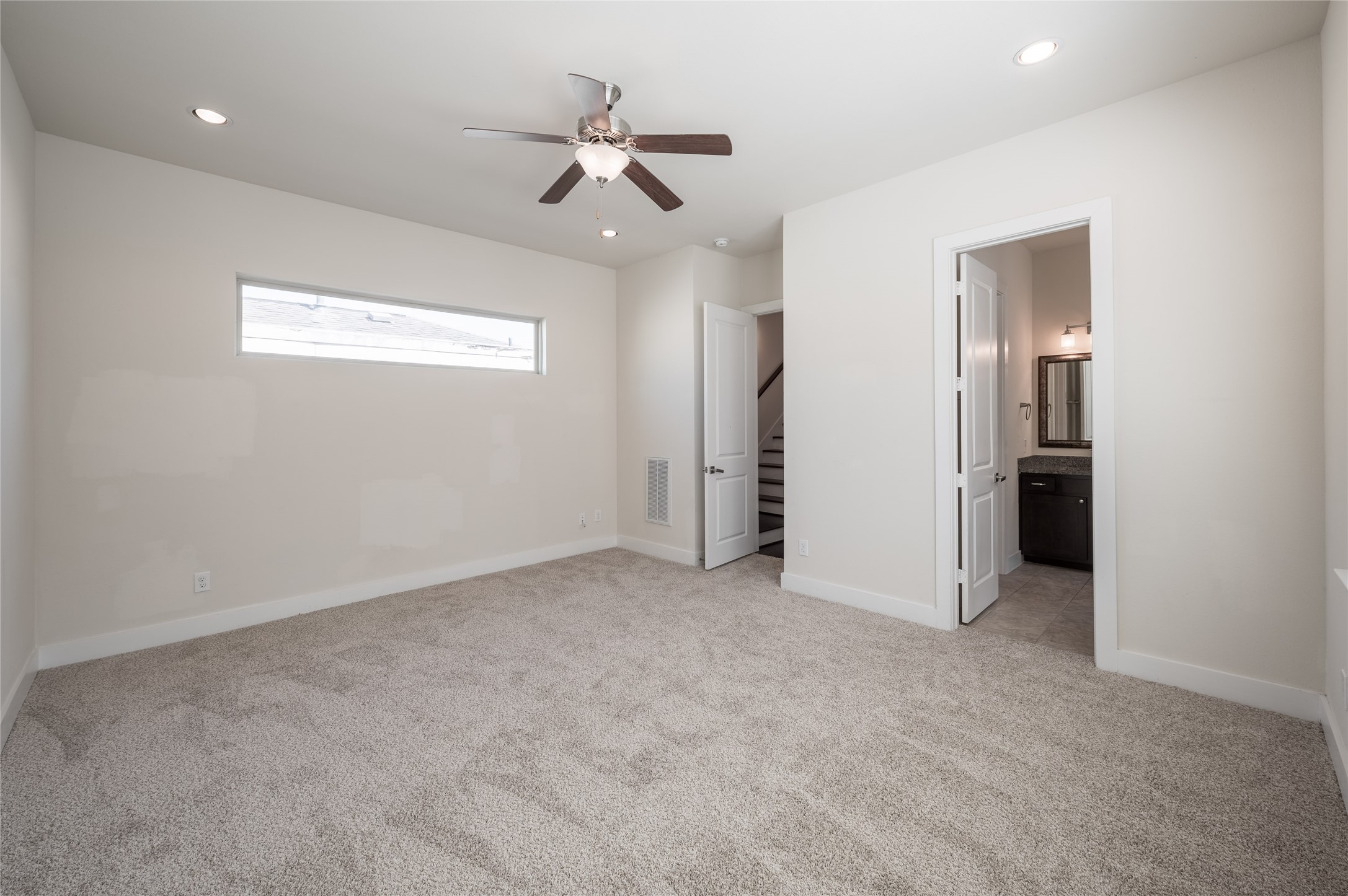 4408 Eli Street, Unit A Houston, TX 77007 - Photo 19 of 22 an empty room with a ceiling fan and carpet