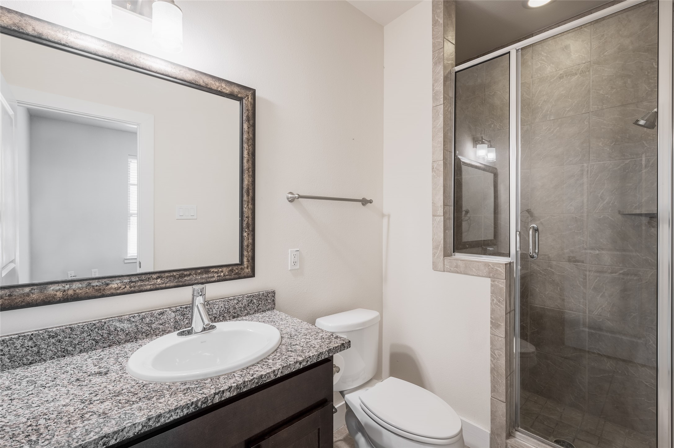 4408 Eli Street, Unit A Houston, TX 77007 - Photo 20 of 22 a bathroom with a granite countertop sink toilet a mirror and shower