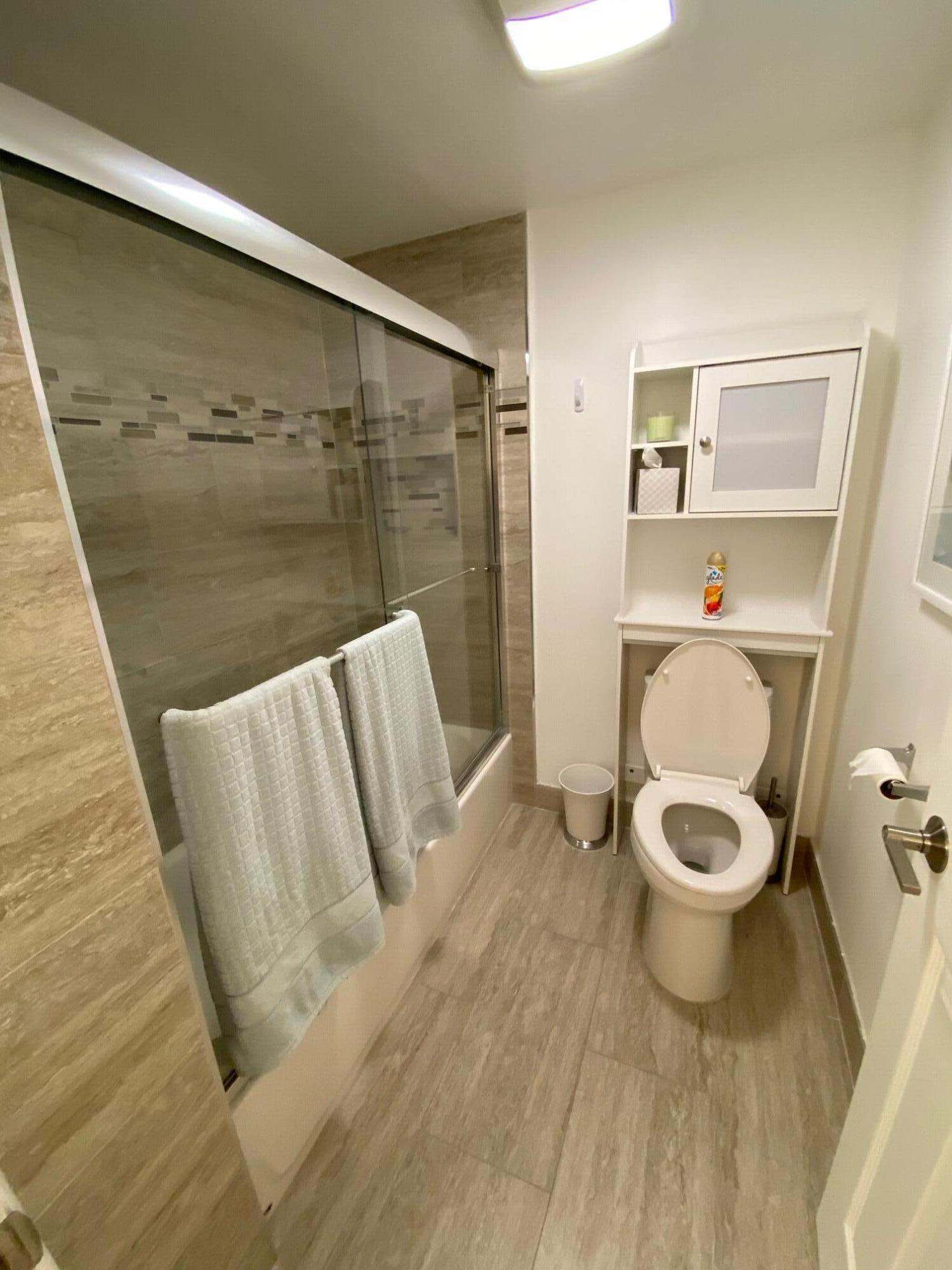 9285 Vista Del Lago, Unit 36F Boca Raton, FL 33428 - Photo 14 of 24 a bathroom with a toilet and a shower