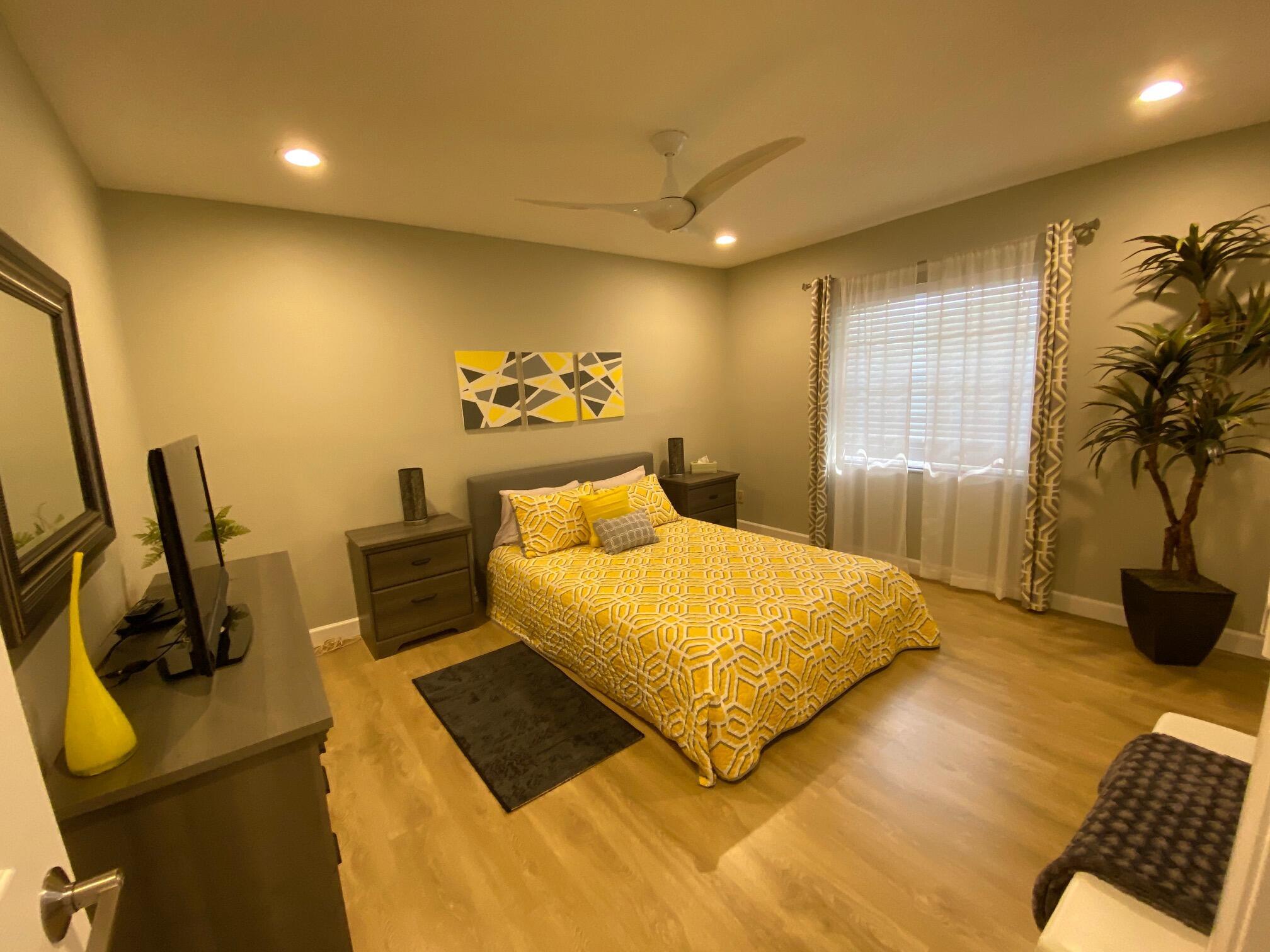 9285 Vista Del Lago, Unit 36F Boca Raton, FL 33428 - Photo 17 of 24 a bedroom with a bed and wooden floor