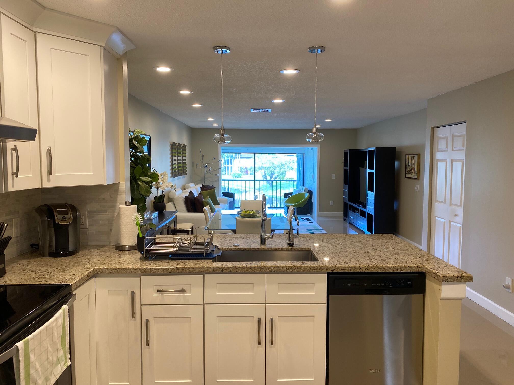 9285 Vista Del Lago, Unit 36F Boca Raton, FL 33428 - Photo 2 of 24 a kitchen with counter top space cabinets and appliances