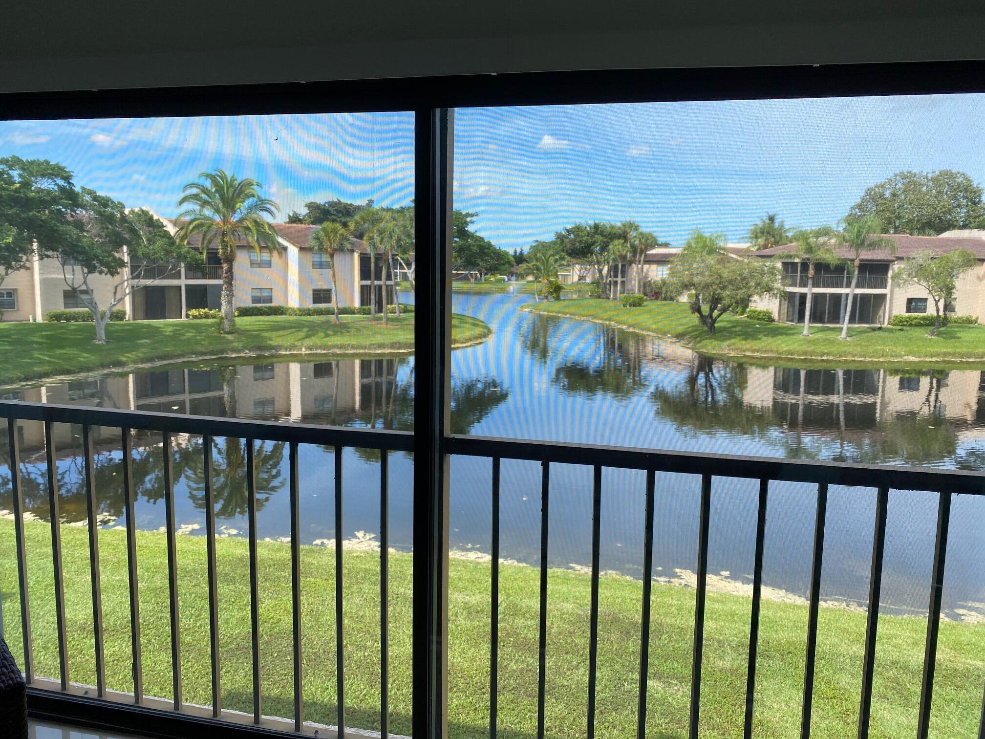 9285 Vista Del Lago, Unit 36F Boca Raton, FL 33428 - Photo 21 of 24 a view of building from a balcony