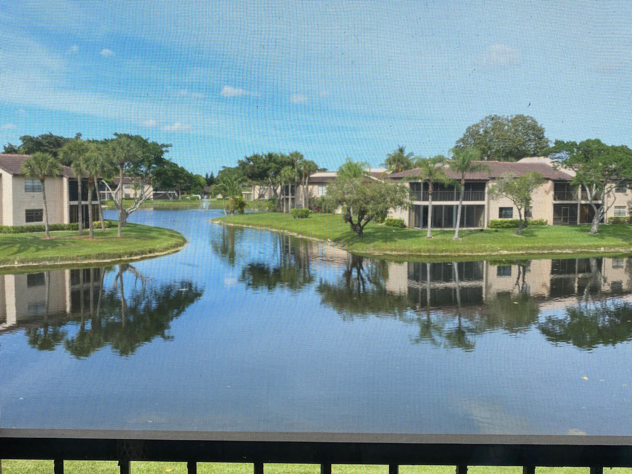 9285 Vista Del Lago, Unit 36F Boca Raton, FL 33428 - Photo 22 of 24 an aerial view of a house with a lake view