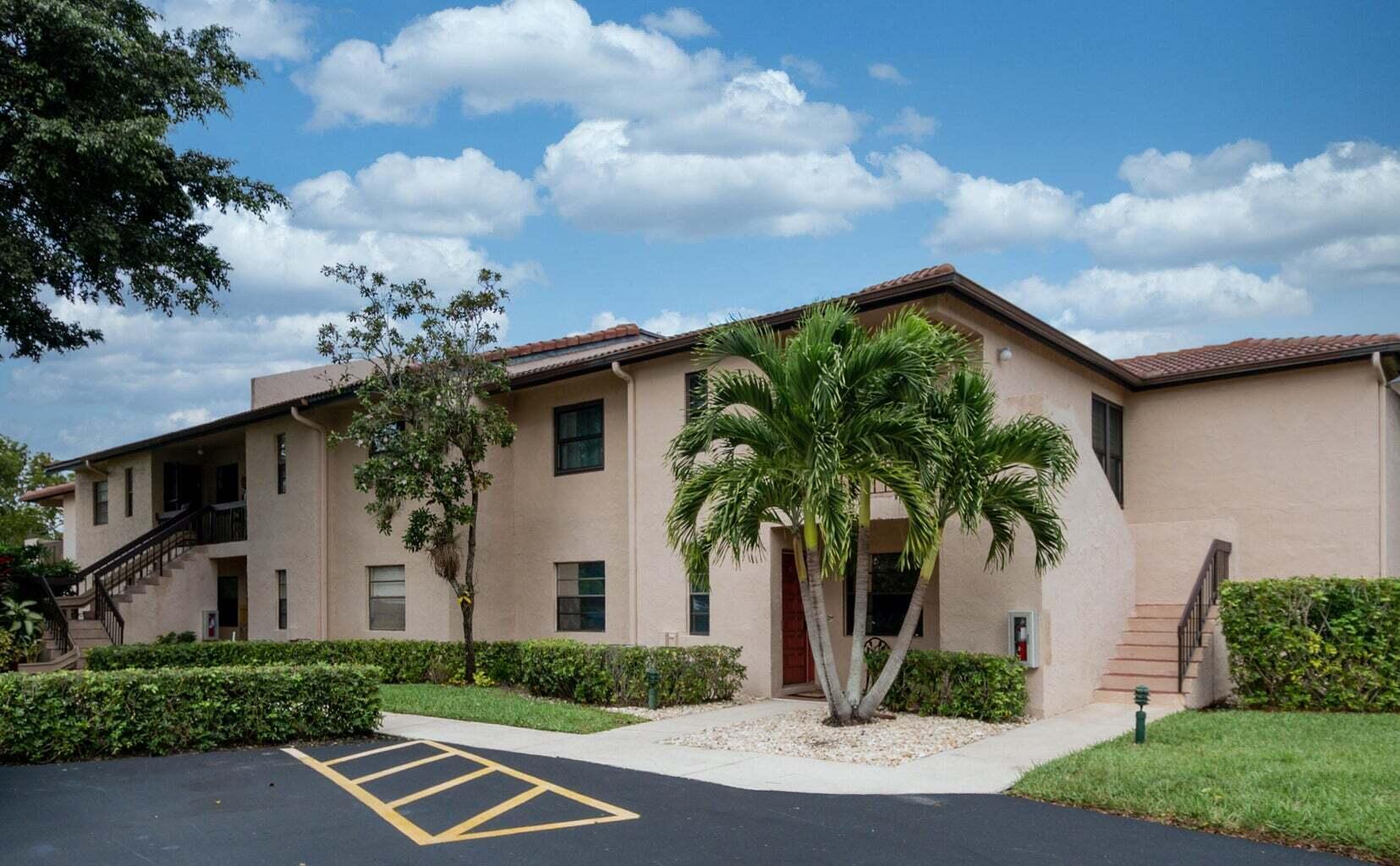 9285 Vista Del Lago, Unit 36F Boca Raton, FL 33428 - Photo 24 of 24 a front view of a house with garden