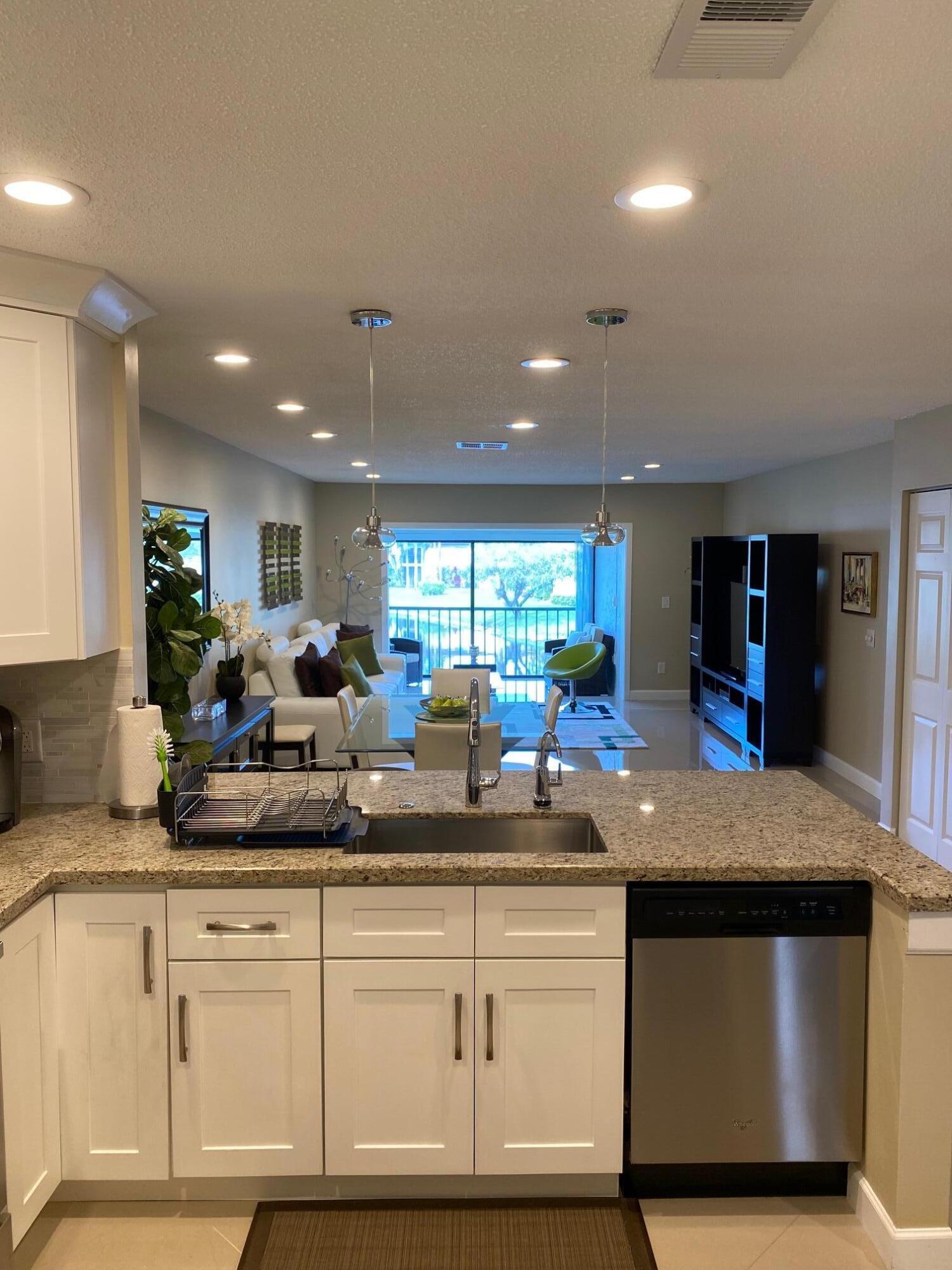 9285 Vista Del Lago, Unit 36F Boca Raton, FL 33428 - Photo 3 of 24 a kitchen with counter top space and living room