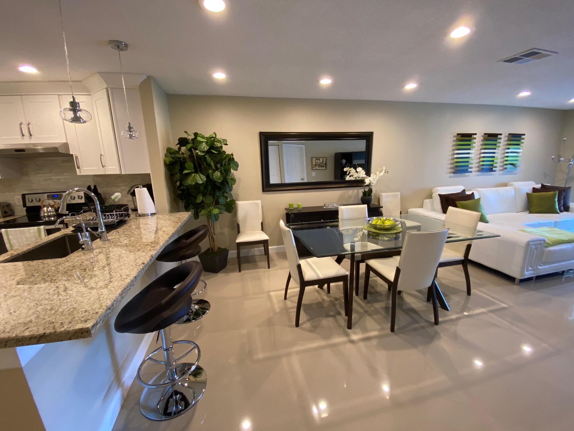 9285 Vista Del Lago, Unit 36F Boca Raton, FL 33428 - Photo 6 of 24 a living room with furniture and a flat screen tv