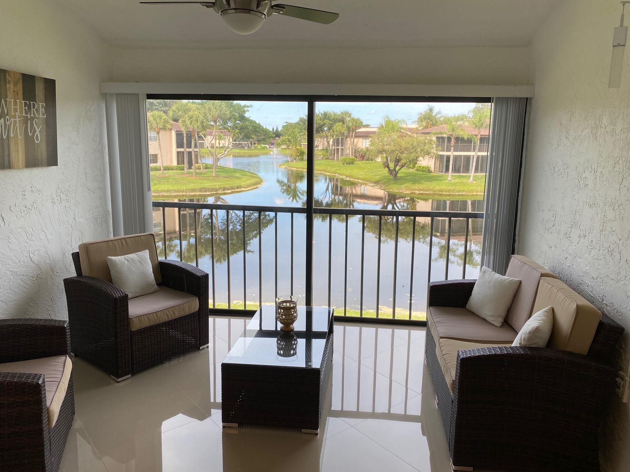 9285 Vista Del Lago, Unit 36F Boca Raton, FL 33428 - Photo 10 of 24 a balcony with furniture and a garden