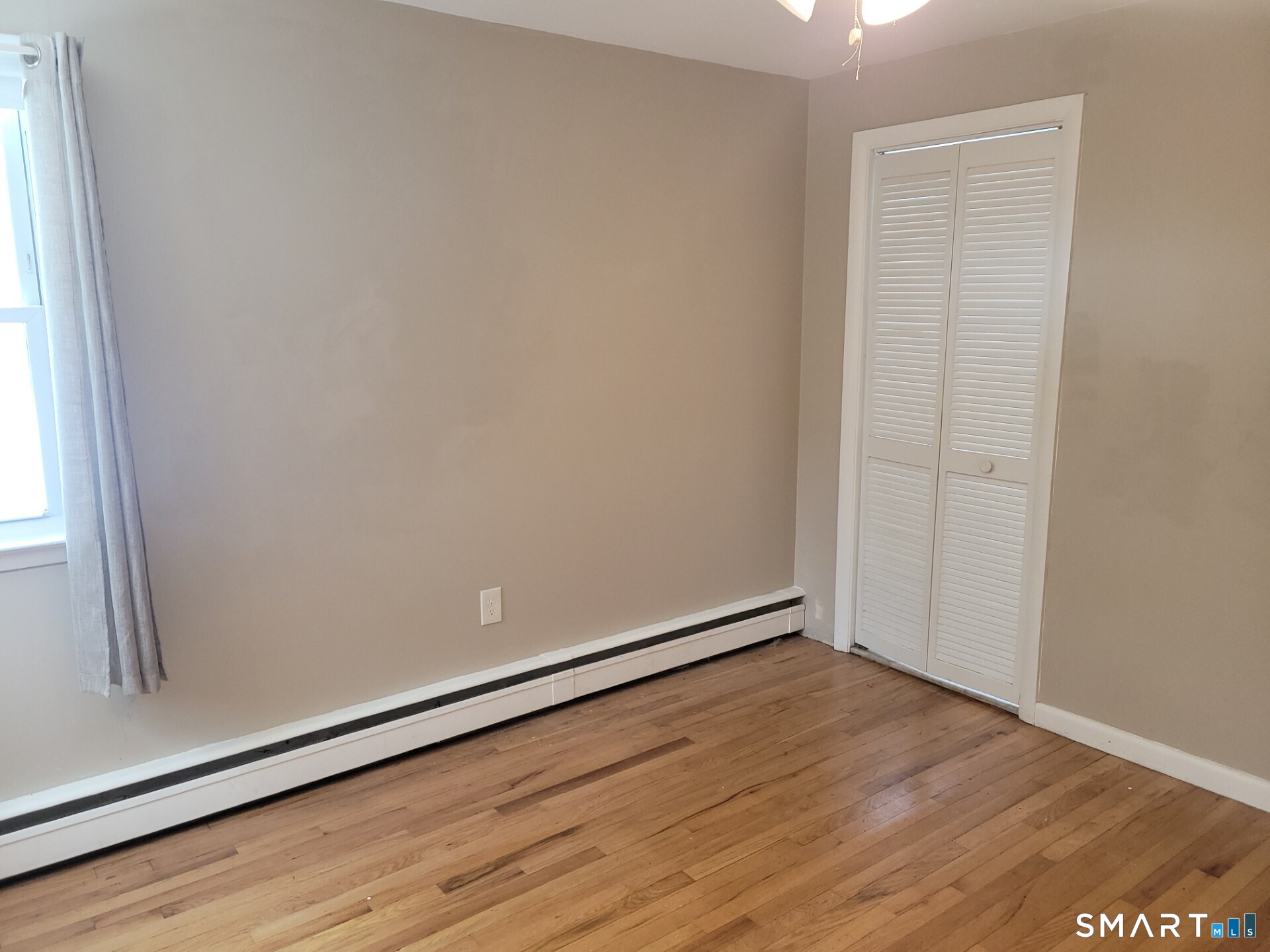 41 East Granby Road Granby, CT 06035 - Photo 11 of 61 an empty room with wooden floor and windows