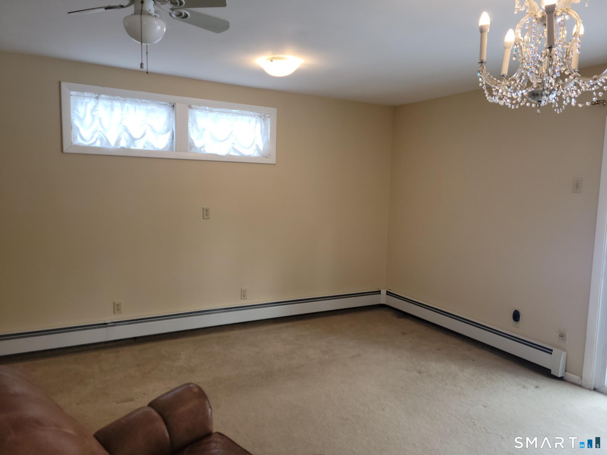 41 East Granby Road Granby, CT 06035 - Photo 19 of 61 en empty room with windows and chandelier fan