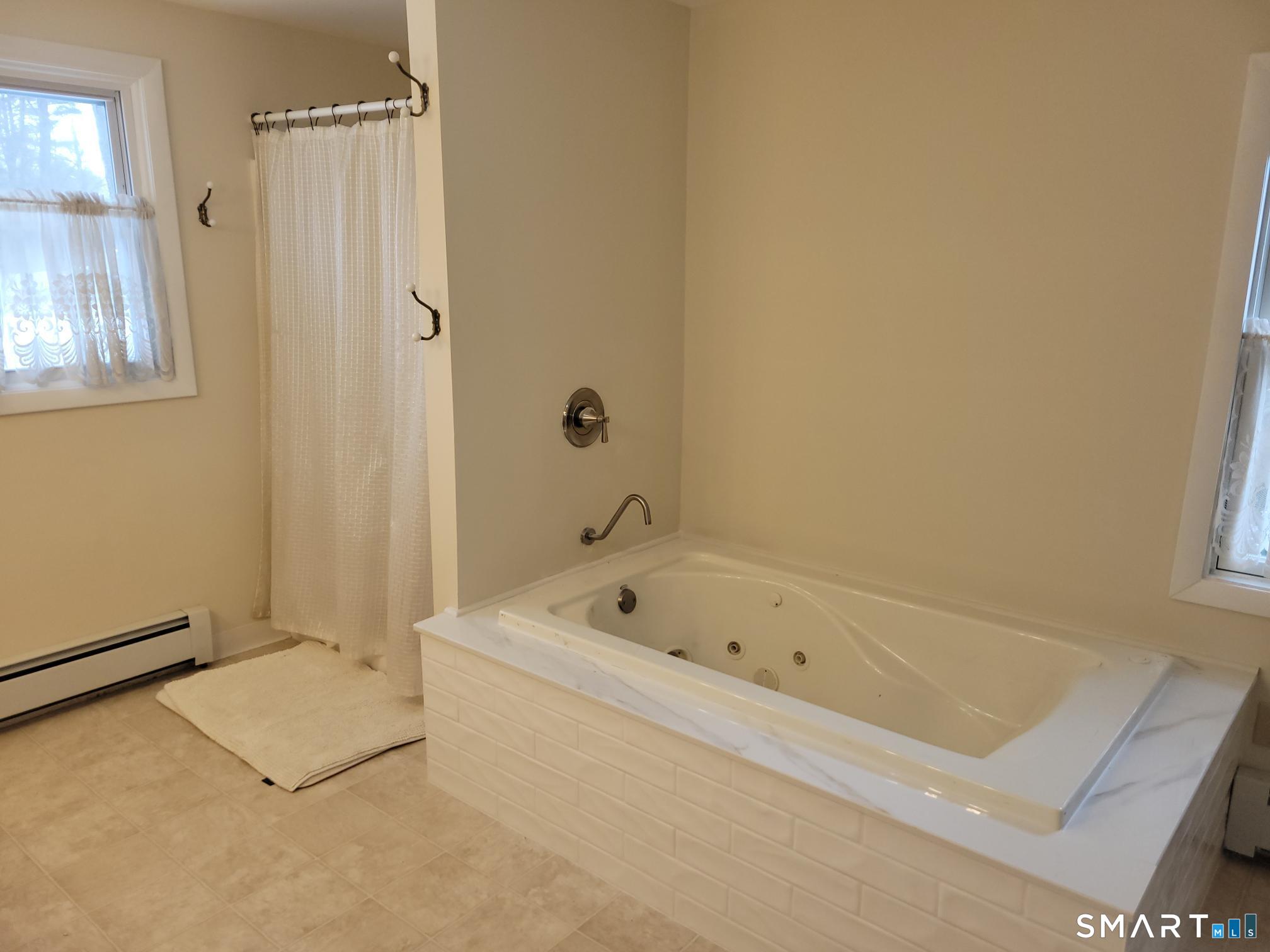 41 East Granby Road Granby, CT 06035 - Photo 30 of 61 a bathroom with a tub a window and a shower