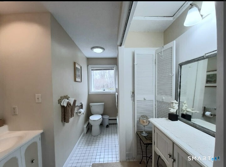 41 East Granby Road Granby, CT 06035 - Photo 49 of 61 a bathroom with a sink a toilet and a mirror
